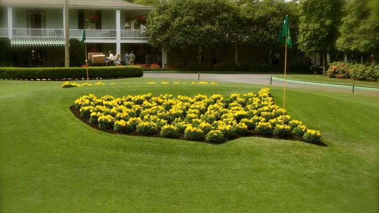 The Masters logo planted in yellow flowers in front of the Augusta National clubhouse