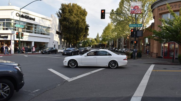 Intersection at the Broadway Plaza outdoor mall in Walnut Creek, California, with shops and passing cars