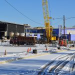 An elementary school building under construction with a crane