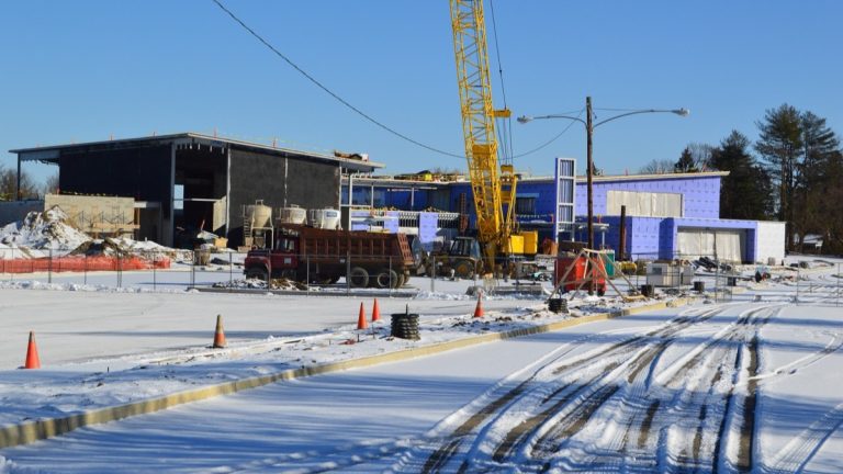 An elementary school building under construction with a crane