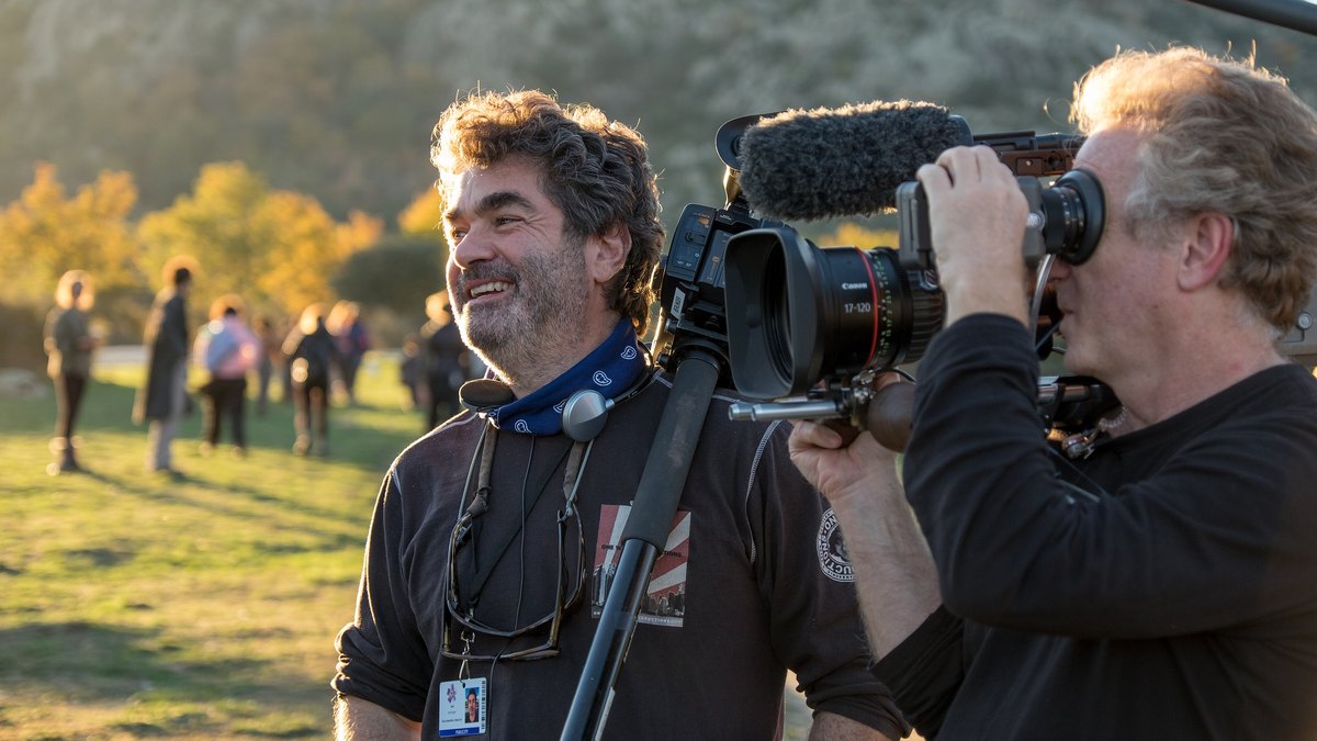 Documentary director Joe Berlinger standing beside a cameraman during an outdoor shoot