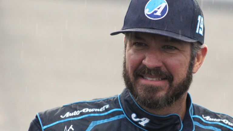 NASCAR driver Martin Truex Jr. in a cap and racing suit