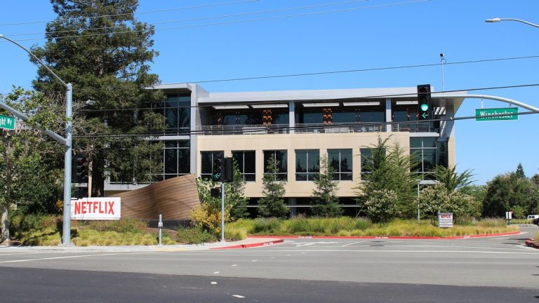 Office building with a Netflix sign on the company's headquarters campus in Los Gatos, California