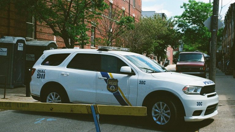 A white Philadelphia Police Department SUV parked across a residential street