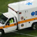 A volunteer rescue squad ambulance driving onto a field