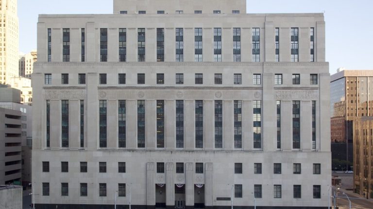 Front of the Theodore Levin United States Courthouse, a limestone federal building in downtown Detroit