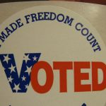 An I Voted sticker held in a hand
