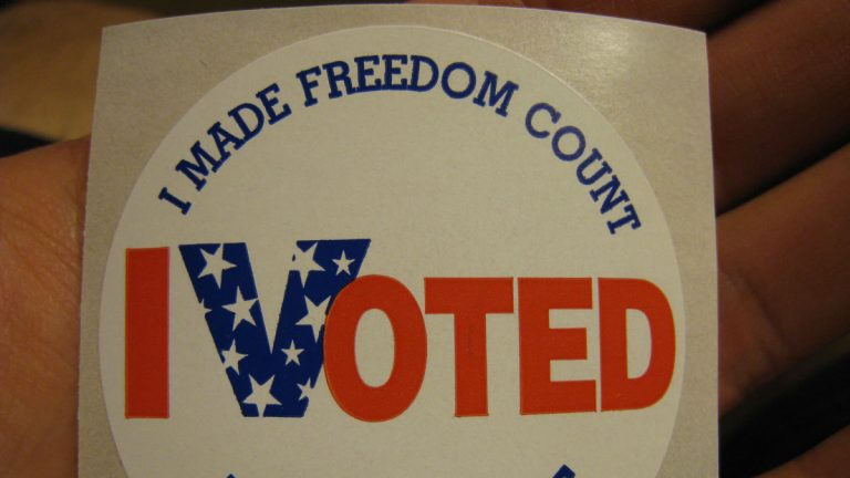 An I Voted sticker held in a hand